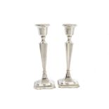 A pair of George V silver filled candlesticks, Chester 1918, some denting, 20cm (2)
