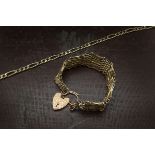 A Victorian 9ct gold gate link bracelet, multiple long and short links with a safety chain and heart