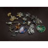 A colletion of costume jewellery, including several enamelled items, along with earrings and more (