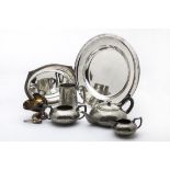 A collection of silver plated items, including a Christofle circular tray, a pepper grinder, toast