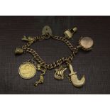 A vintage gold charm bracelet, the 9ct gold part curb link watch chain with multiple charms such