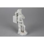 A Hochst White Porcelain Figurine of an Itinerant Magic Lanternist, the showman with a large magic