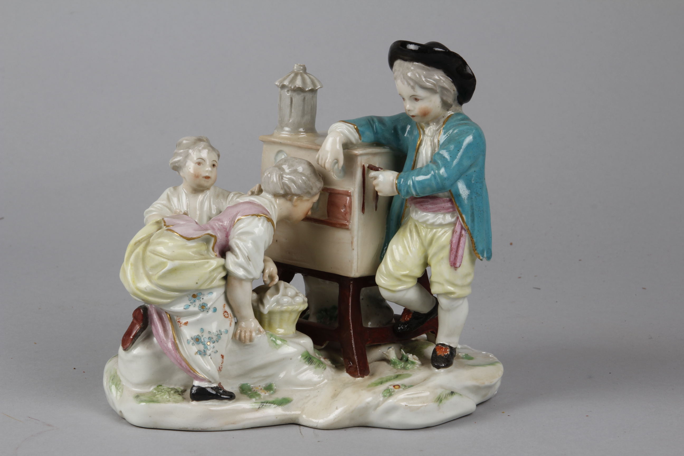 A Derby Porcelain Figurine Group of a Peepshow Man, numbered 94 on the base, it was first produced