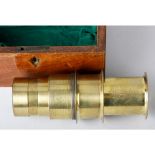 A C & F Darker Lacquered Brass Projecting Kaleidoscope Lens, in mahogany case, 180mm wide, circa