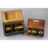 Three Brass Bound Lenses for a Magic Lantern in Two Fitted Boxes, one box, 270mm wide, containing