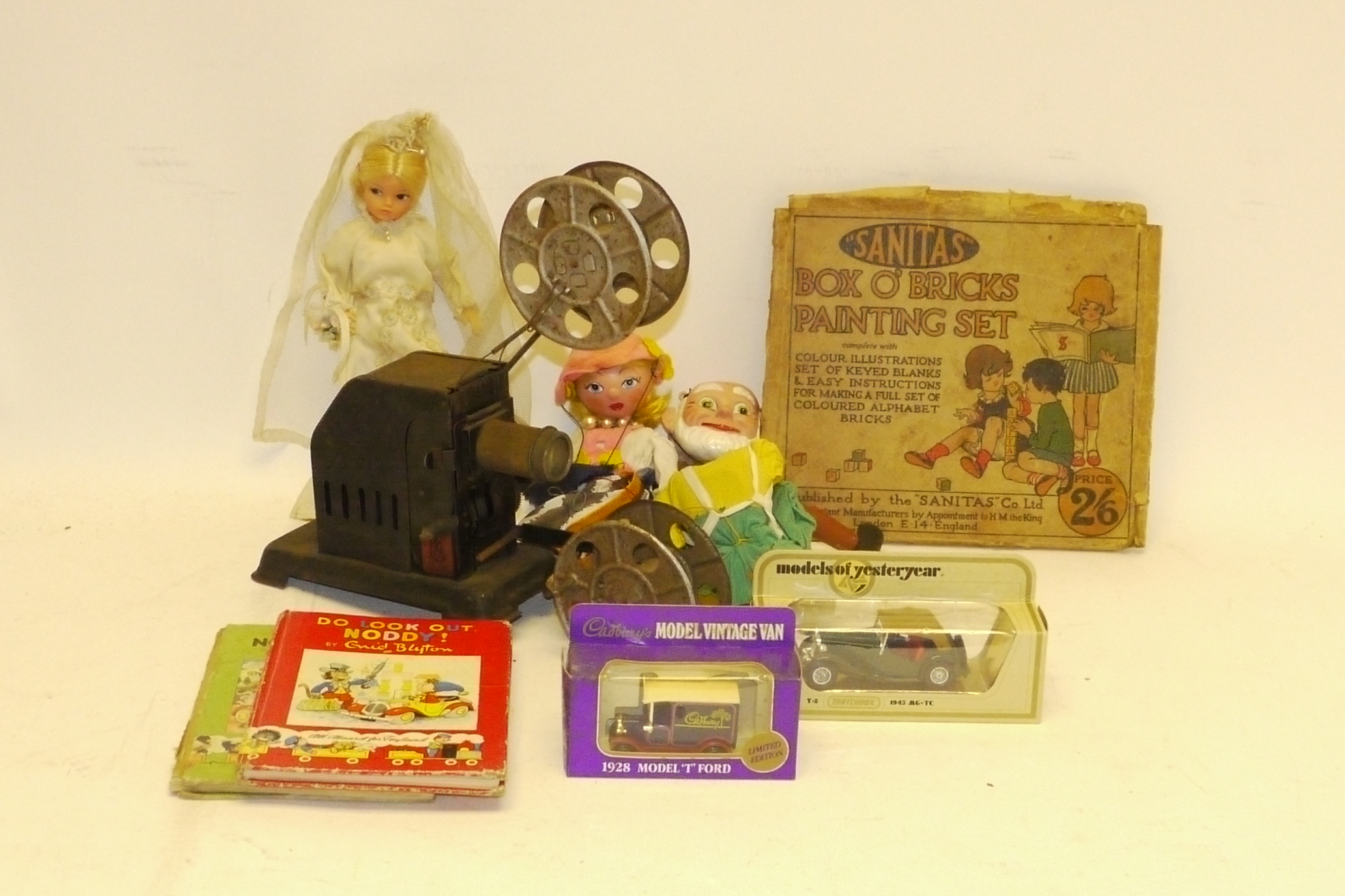 Bing British Projector, 35mm hand cranked tin toy projector with three film reels in canisters in