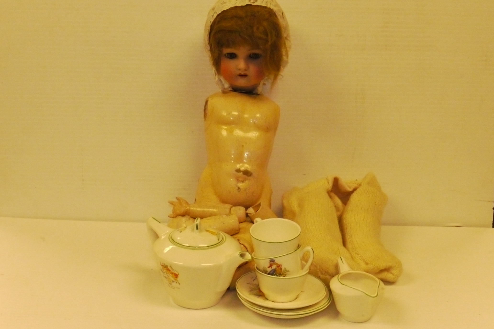 Ceramic Doll's Head, painted features, blue flirty eyes, dark blonde hair covered by a lace