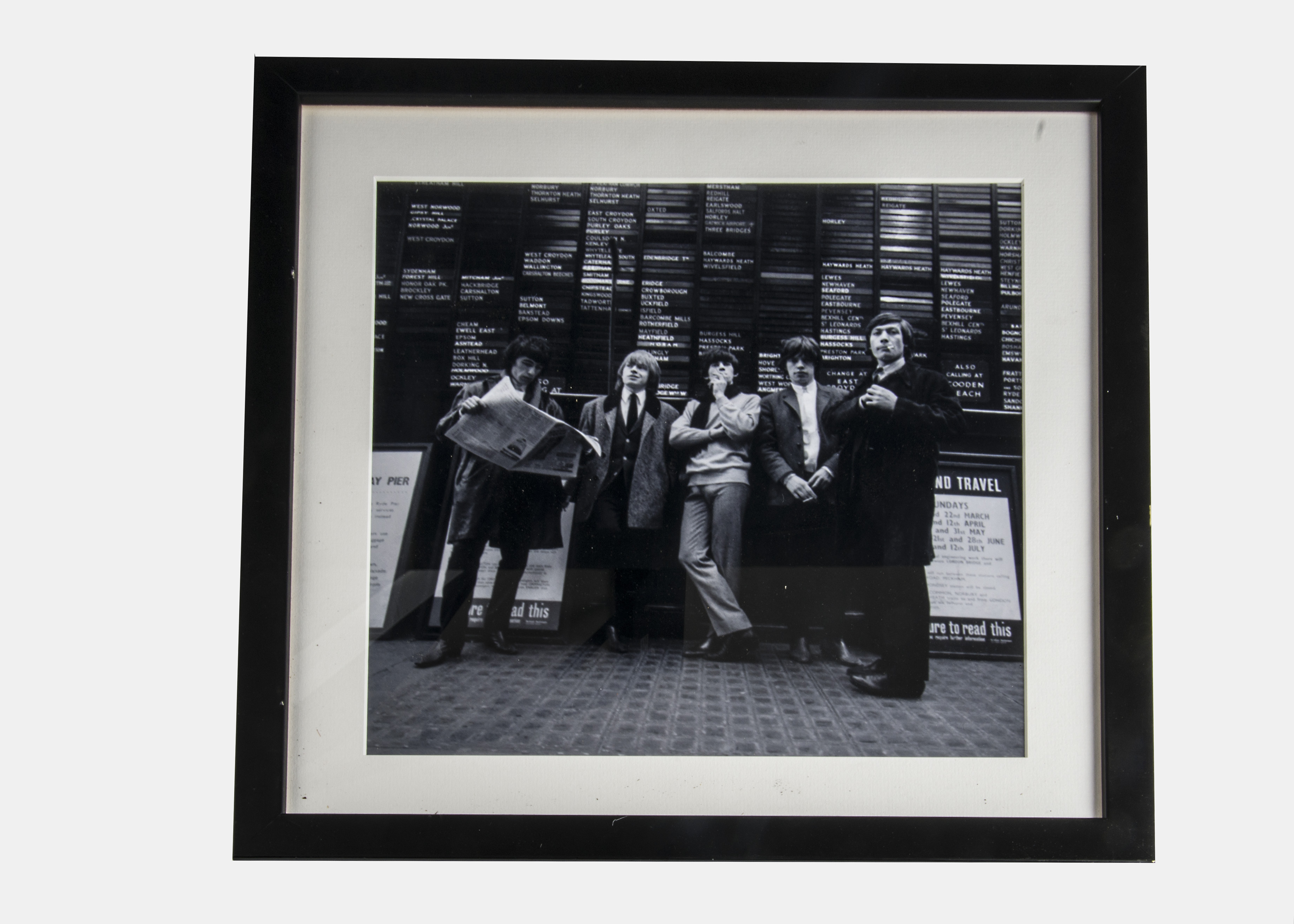 The Rolling Stones, framed and glazed photograph of the group standing outside Victoria station 1965