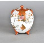 A Japanese Meiji period porcelain vase and cover, the ovoid body with bat moulded handles