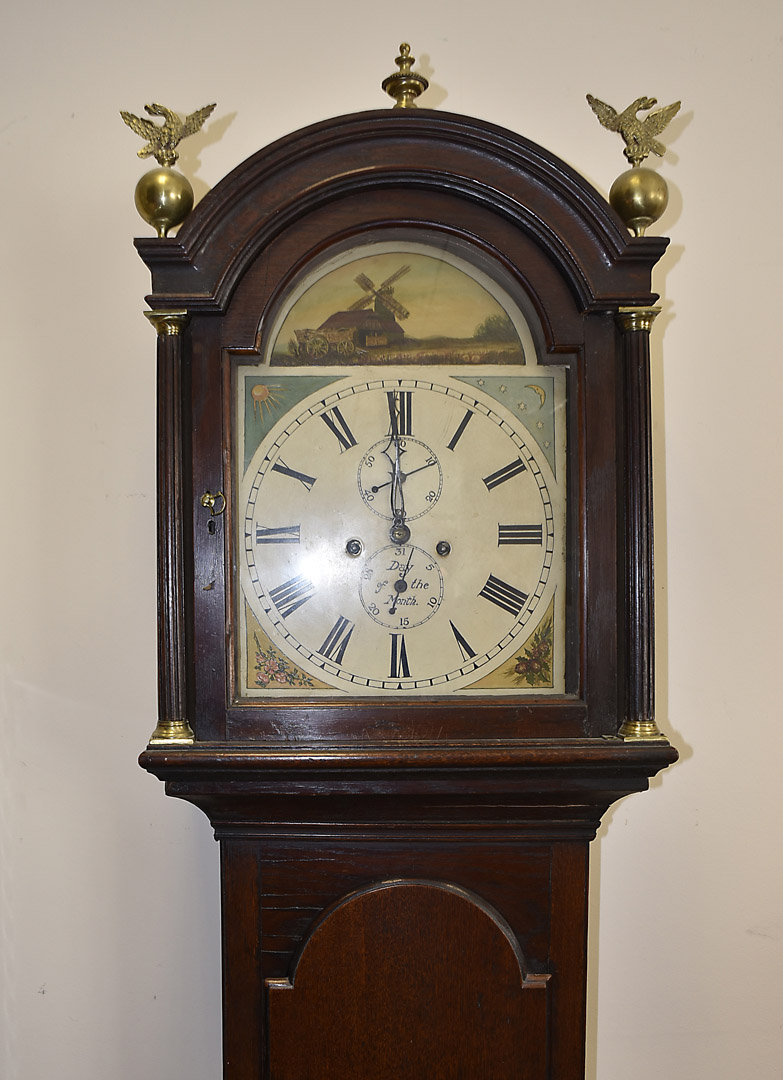 An eight day long case clock, oak case, painted dial, roman numerals, two subsidiary dials, dome