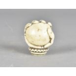 A 19th Century ivory cane handle, modelled as a hand clutching a ball with frilly collar