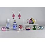 A collection of modern glass paperweights, including a blue glass flashed scent bottle and