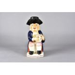 A 19th Century Staffordshire toby jug and cover, modelled as seated gentleman with foaming jug of