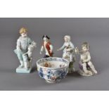 A Meissen figure of a seated putti with posies of flowers, on rococo base 8 cm H, plus a pair of