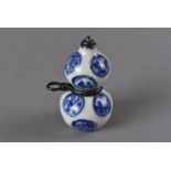 A Meiji period Japanese double gourd porcelain netsuke and snuff bottle, A Meiji period Japanese