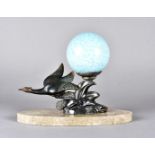 An art deco spelter table lamp, modelled as a flying sea bird on a rock formation signed Limousin