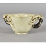 A 19th Century Chinese soapstone carved libation cup, the circular vessel supported on a small