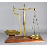 A W & T Avery set of brass balance scales, on a mahogany base together with a set of Day and