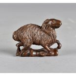 A Japanese hardwood netsuke, carved as a ram, black glass eyes, signed to base, 5.5 cm