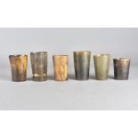A collection of six late 18th or early 19th Century horn beakers, three having turned bases, of