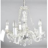 A five branch moulded and cut glass chandelier, having central shaped stem with domed lower section,