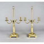 A pair of brass twin branch table lights, the scroll arms supported on fluted column stems, on