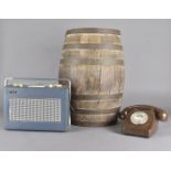 A coopered ovoid oak barrel, 54 cm high, containing a BT 8746 G brown telephone and a BBC Hacker
