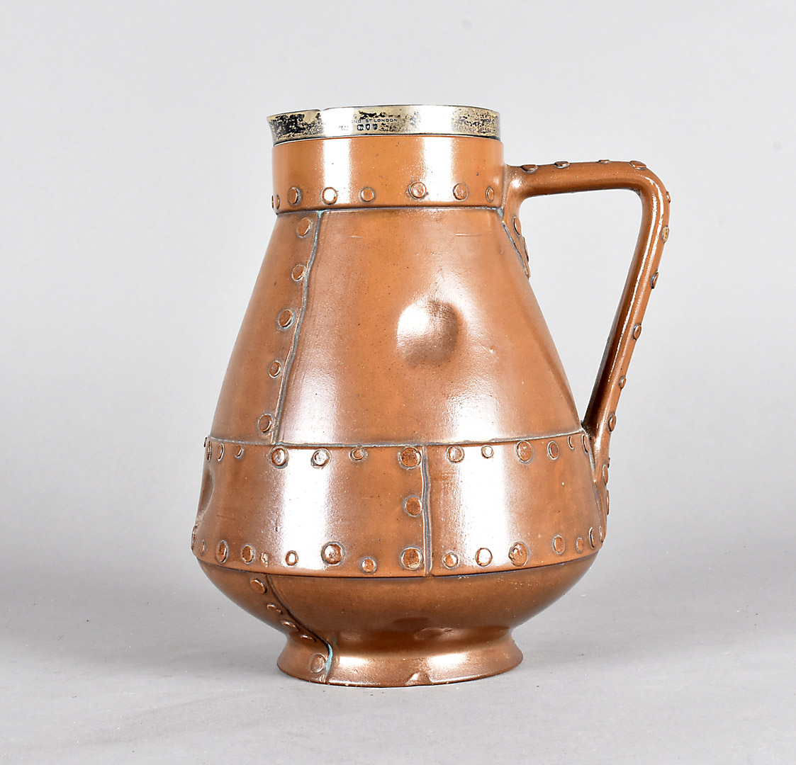 A Doulton Silicon Lambeth pottery jug, simulating a copper jack with silver collar by Thornhill Bond