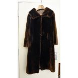 A three quarter length lady's fur coat, the brown beaver with a green and pink silk style lining
