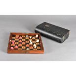 A travelling Jaques & Sons patent London in Status Quo chess board, the mahogany case folding out to