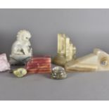 A collection of alabaster book ends, including a pair of Chinese lion dogs, a pair of deco