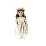 A Heinrich Handwerck child doll, with blue lashed sleeping eyes, brown synthetic wig, jointed