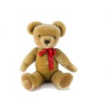 A Merrythought teddy bear, with golden mohair, jointed, velvet pads and golden label -28in. (