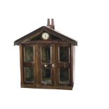 An early small dolls’ cupboard house 1820-30s, the brick painted roof and sides with two chimney