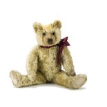 A 1920s Farnell teddy bear, with blonde mohair, clear and black glass eyes with remains of brown