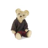 A 1920s British teddy bear, with blonde mohair, clear and black glass eyes with brown painted backs,