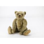 A 1920s Farnell teddy bear, with blonde mohair, clear and black glass eyes with orange painted