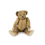 An early German teddy bear circa 1909, probably Strunz with brown mohair, black boot button eyes,