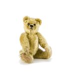 A small Farnell teddy bear 1920s, with light golden mohair, clear and black glass eyes, pronounced