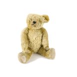 A large interesting French 1930s teddy bear, possibly Fadap with golden mohair, clear and black