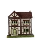 A carpenter or toyman built timber framed dolls’ house, painted in brown and cream with porched