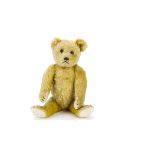 A 1920s German teddy bear, with golden mohair, black boot button eyes, black stitched nose, mouth