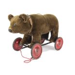 An unusual Chad Valley bear on wheels 1930s, with dark brown mohair, clear and black glass eyes with