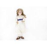 A German bisque headed Special child doll, possibly Kley & Hahn with brown sleeping eyes, replaced