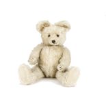 A Diem white mohair teddy bear 1950s, with brown and black glass eyes, short mohair muzzle and pads,