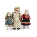 Three dolls’ house dolls: a German bisque headed with fixed blue glass eyes, blonde mohair wig,