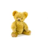 A Knickerbocker musical teddy bear 1950s, with golden mohair, clear and black glass eyes, inset