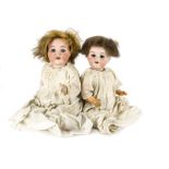 Two Armand Marseille character babies: a 990 with brown lashed sleeping eyes and brown mohair wig,