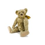 A large 1920s Farnell teddy bear, with blonde mohair, clear and black glass eyes, pronounced clipped