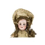 A DEP child doll, with brown lashed sleeping eyes, pierced ears, brown hair wig on sawdust pulp